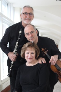 Strata musicians sitting with instruments in black shirts