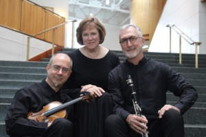 James Stern, Audrey Andrist and Nathan Williams in a row on the steps of a concert hall